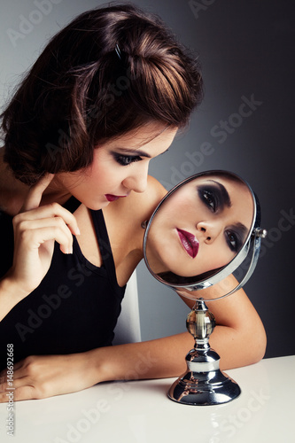 Beautiful woman with mirror