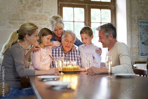 Family celebrating grandfather birthday together