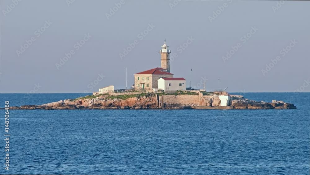 Lighthouse on small island in sunrise. Sveti Ivan na Pucini, near Rovinj, Croatia Lighthouse on small island in sunrise. Sveti Ivan na Pucini, near Rovinj, Croatia