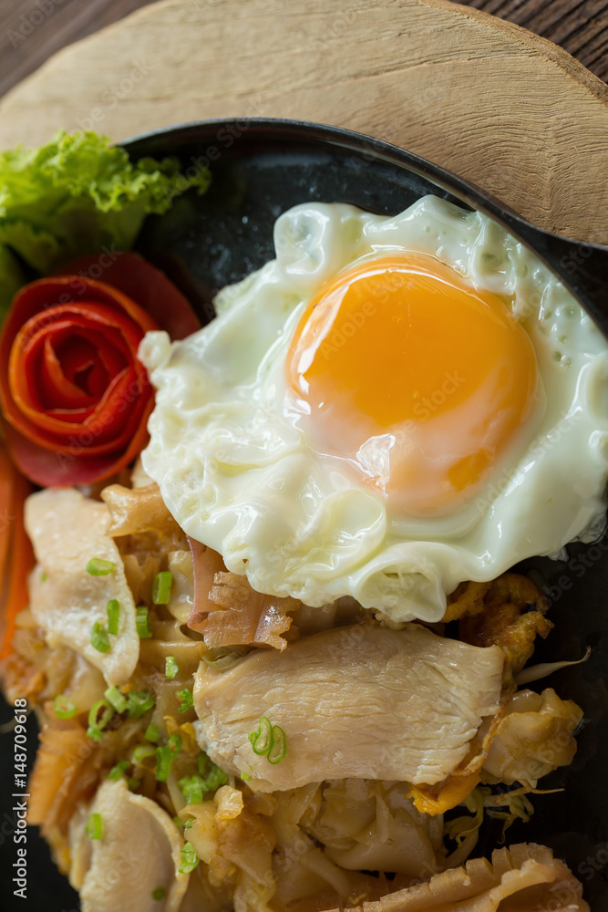 Asian noodles with fresh green onion and fried egg on old wood table Asian noodles with fresh green onion and fried egg on old wood table