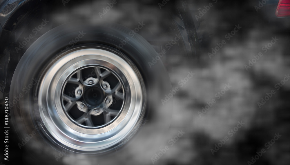 Isolated sport car wheel with drifting and smoking on a black background Isolated sport car wheel with drifting and smoking on a black background