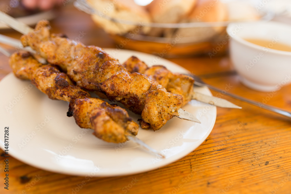 Fried shish kebab on sticks in a cafe