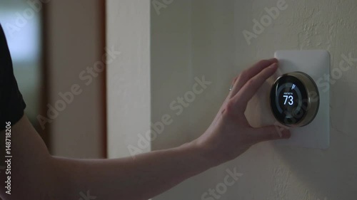 Man Adjusting Smart Thermostat Gadget At Home