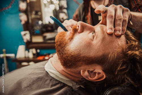 Hipster shears a beard