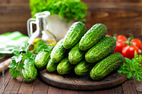 Fresh cucumbers on wooden table photo