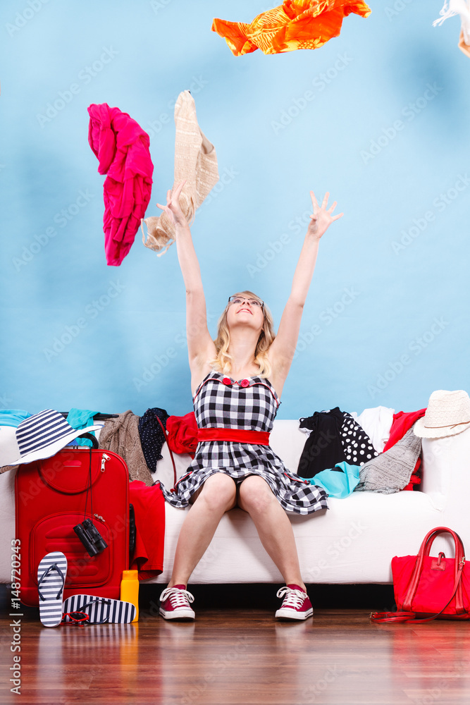 Obraz premium Woman throwing up clothes, clothing flying everywhere