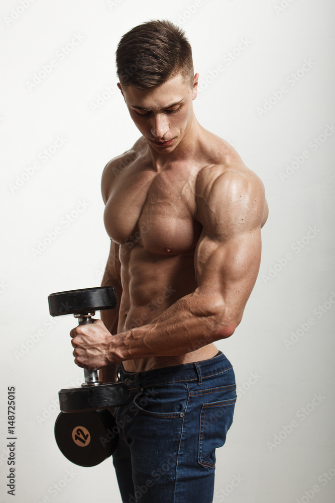 Fototapeta premium Sportsman performing exercises with dumbbells