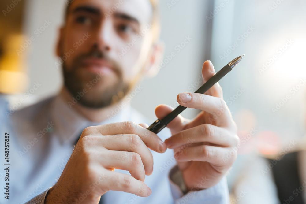 Hands of man holding ballpoint Hands of man holding ballpoint