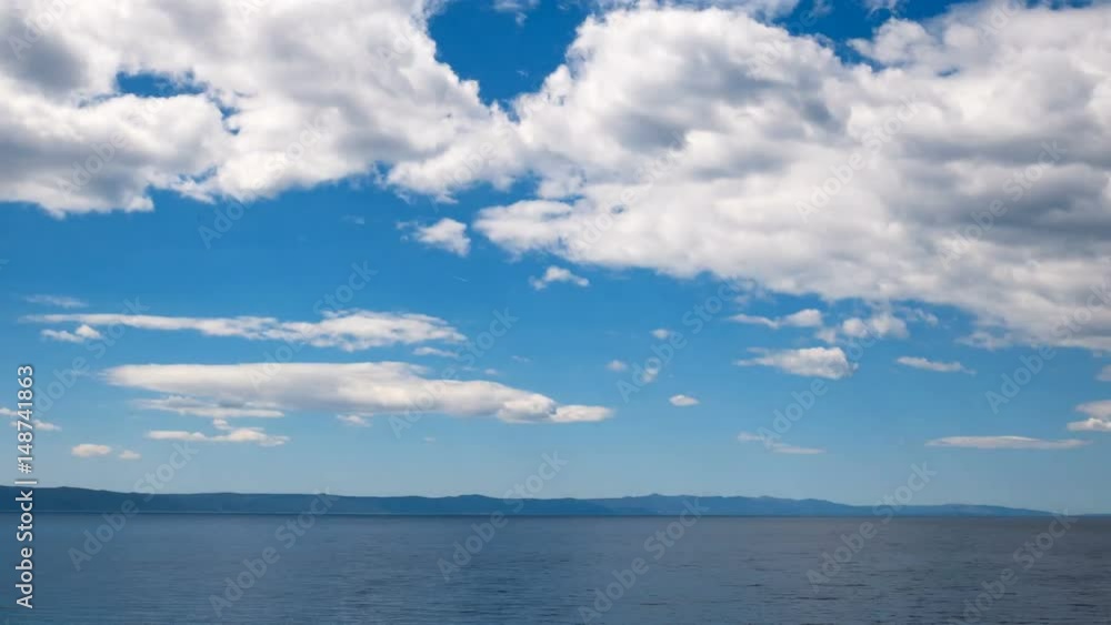 Calm blue sea landscape with island Hvar in Croatia at background and many clouds above time lapse Calm blue sea landscape with island Hvar in Croatia at background and many clouds above time lapse