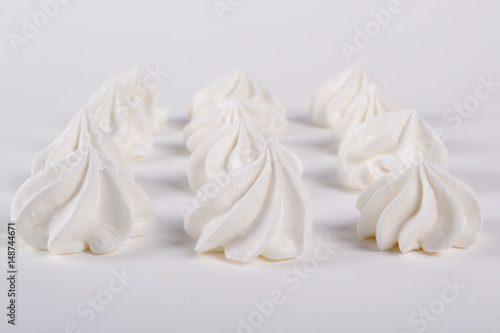 Closeup of mini meringues cookies on white background