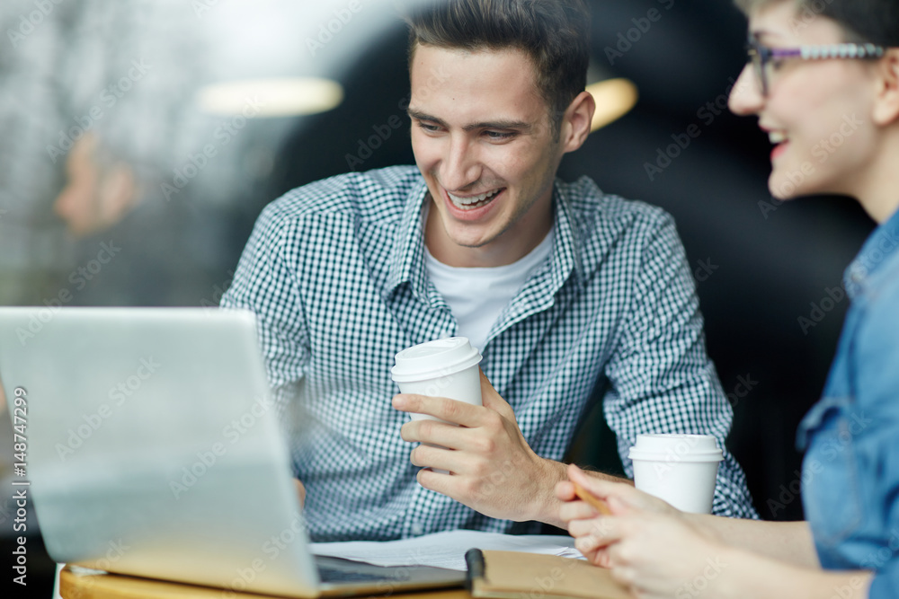Successful professionals reading and discussing online data Successful professionals reading and discussing online data