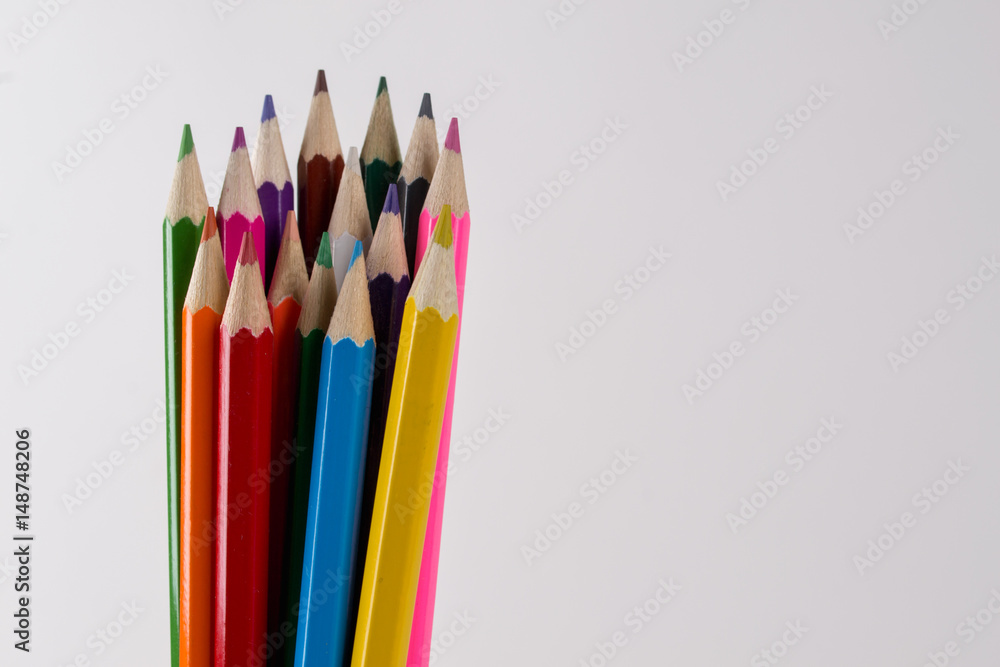 Fototapeta premium Multicolored pencils on white background. Copy space