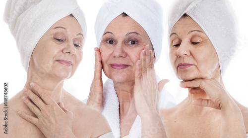 Spa concept. Aged good looking woman with white towel on her head 