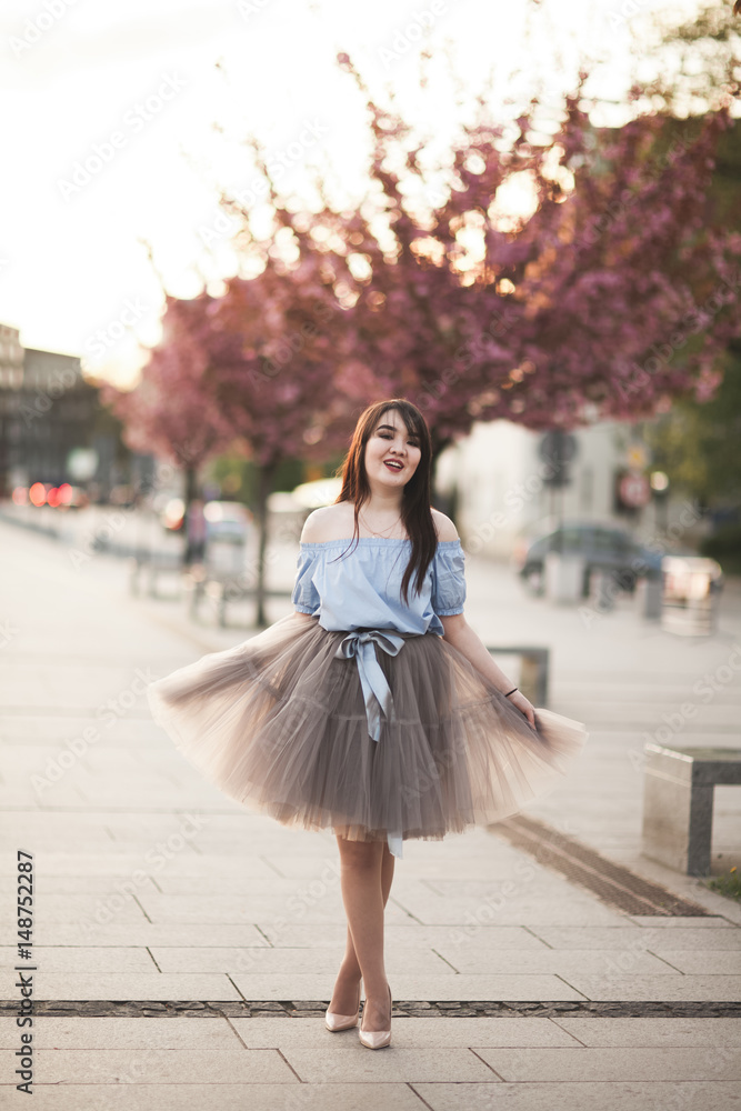 Young Asians girl with modern dress posing in an old Krakow