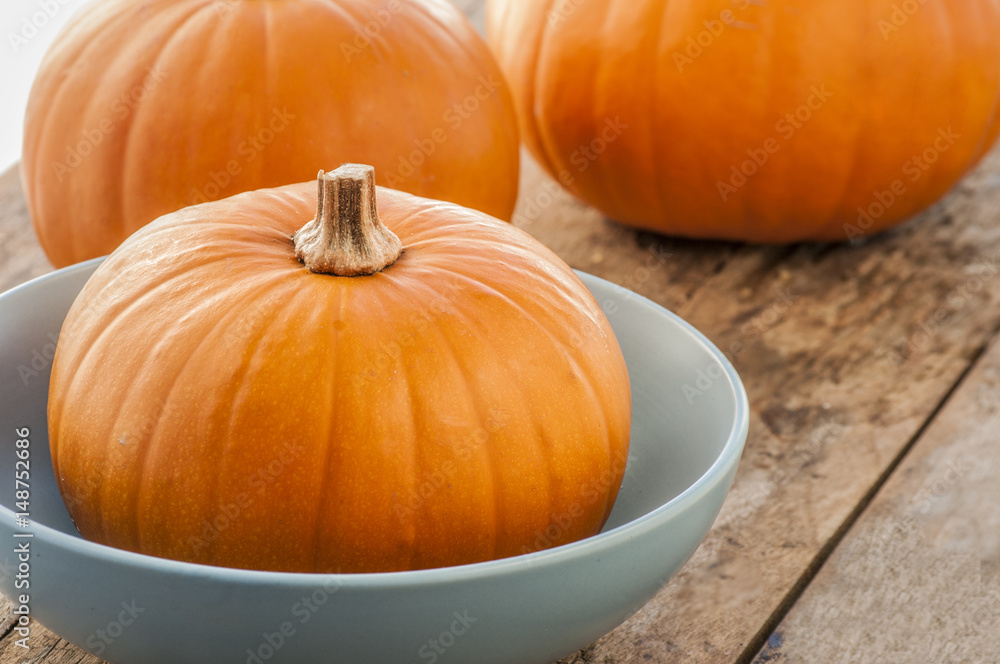 three pumpkins on wooden background three pumpkins on wooden background