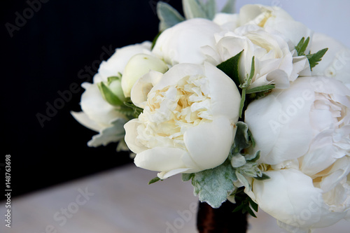 Wedding bouquet of white peonies and ranunculuses.Wedding floristry