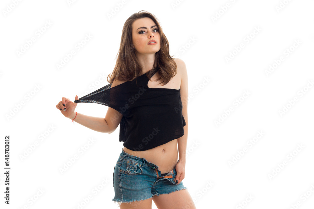 Foto Stock sexy young girl in shorts and t-shirt poses on camera | Adobe  Stock