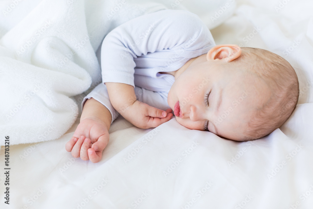 Close-up portrait of adorable baby boy sleeping in bed, 1 year old baby concept Close-up portrait of adorable baby boy sleeping in bed, 1 year old baby concept