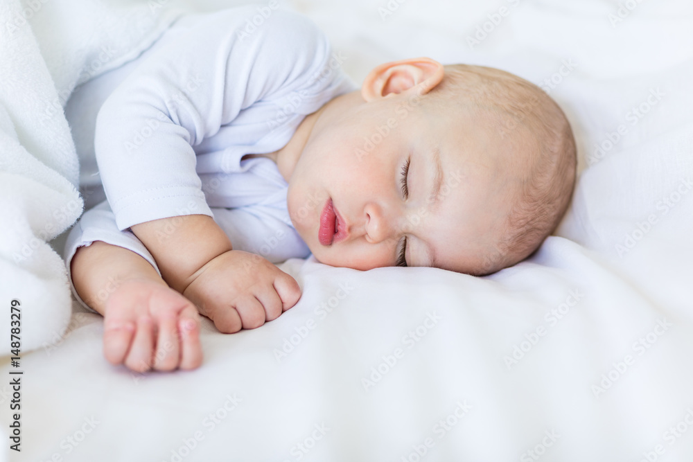 Close-up portrait of adorable baby boy sleeping in bed, 1 year old baby concept Close-up portrait of adorable baby boy sleeping in bed, 1 year old baby concept