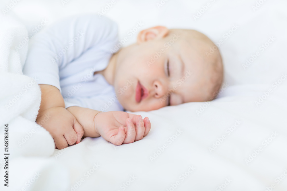 Close-up portrait of adorable baby boy sleeping in bed, 1 year old baby concept Close-up portrait of adorable baby boy sleeping in bed, 1 year old baby concept