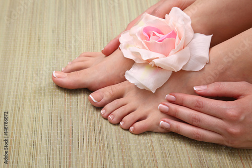 pedicure on legs and beautiful manicure on hands closeup