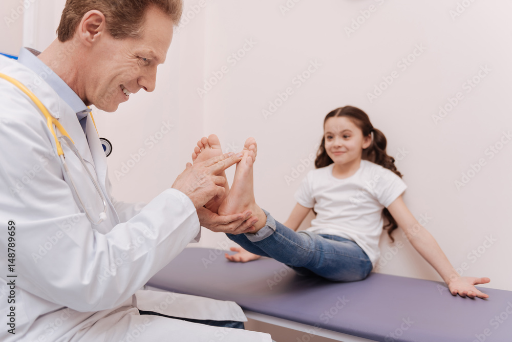 Clever friendly rheumatologist running a regular checkup Clever friendly rheumatologist running a regular checkup