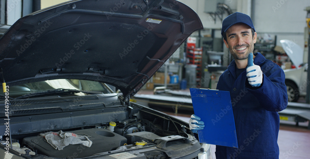 Specialist auto mechanic in the car service, checks the car, engine, engine, carburetor. Concept: repair of machines, fault diagnosis, repair specialist, technical maintenance and on-board computer. Specialist auto mechanic in the car service, checks the car, engine, engine, carburetor. Concept: repair of machines, fault diagnosis, repair specialist, technical maintenance and on-board computer.