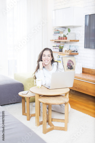 Morning scene. Beautiful woman using laptop at home © nikodash