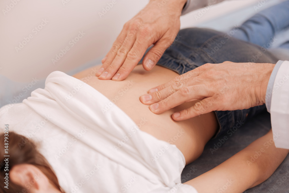 Delicate neat rheumatologist massaging patients back Delicate neat rheumatologist massaging patients back
