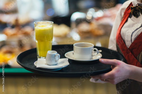 Waitress holding tray with coffee  milk and orange juice.service Service And Beverages Concept .