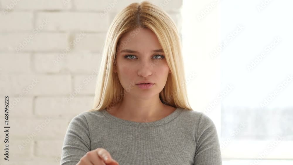 Portrait of Young Woman Pointing at Camera in Office Portrait of Young Woman Pointing at Camera in Office