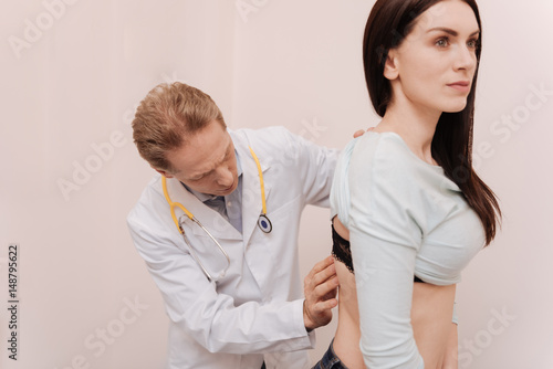Graceful young woman having her spine checked