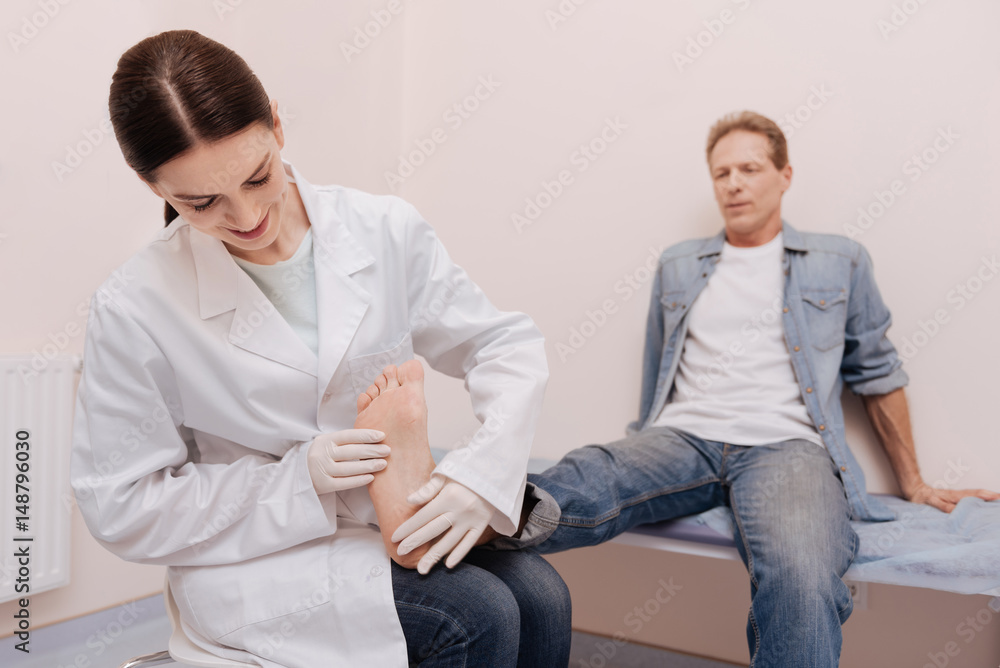 Attentive caring rheumatologist consulting her patient Attentive caring rheumatologist consulting her patient