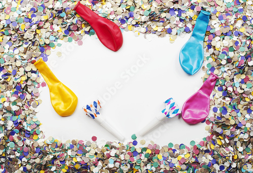 Background of confetti and balloons on white background. Carnival, party, celebration.