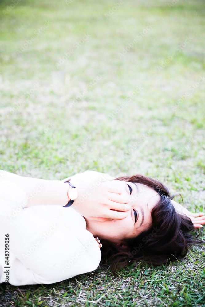 young attractive asian woman Lie on the lawn young attractive asian woman Lie on the lawn