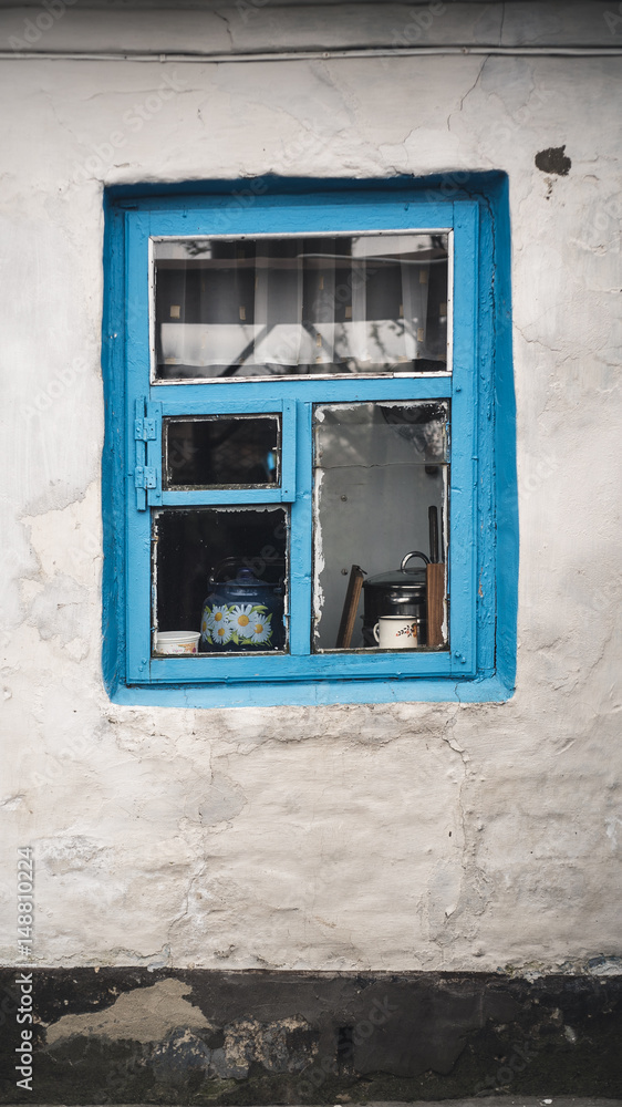 Minimalism scene with a Side wall of damaged building with blue old vintage window