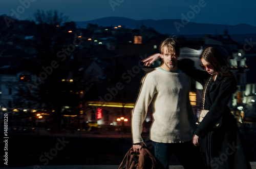 couple of man and girl on blurred night city illumination
