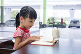 Asian Chinese little girl reading book