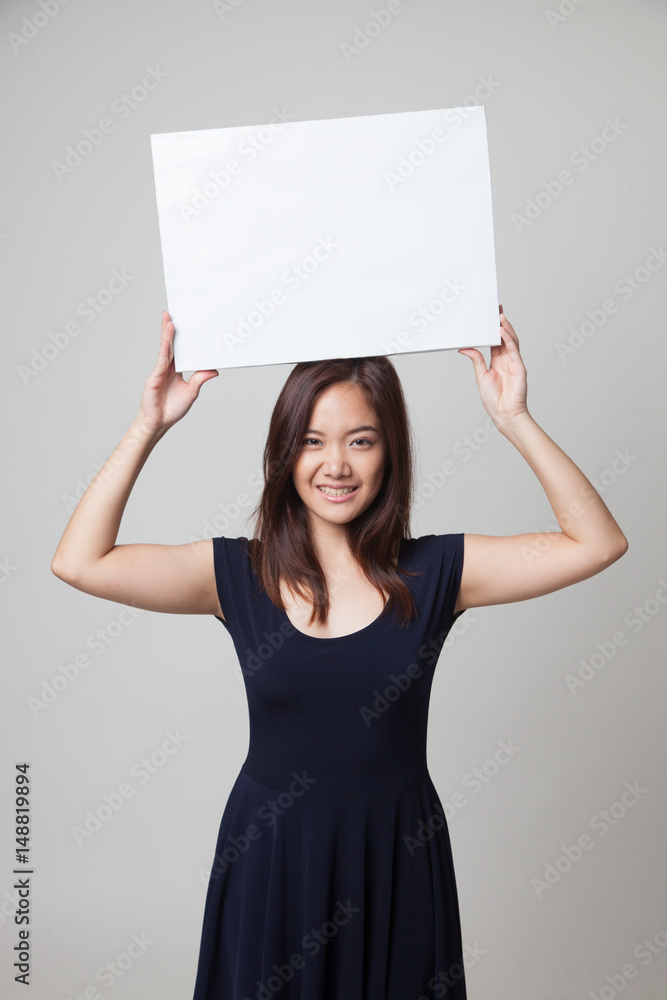 Young Asian woman with white blank sign. Young Asian woman with white blank sign.