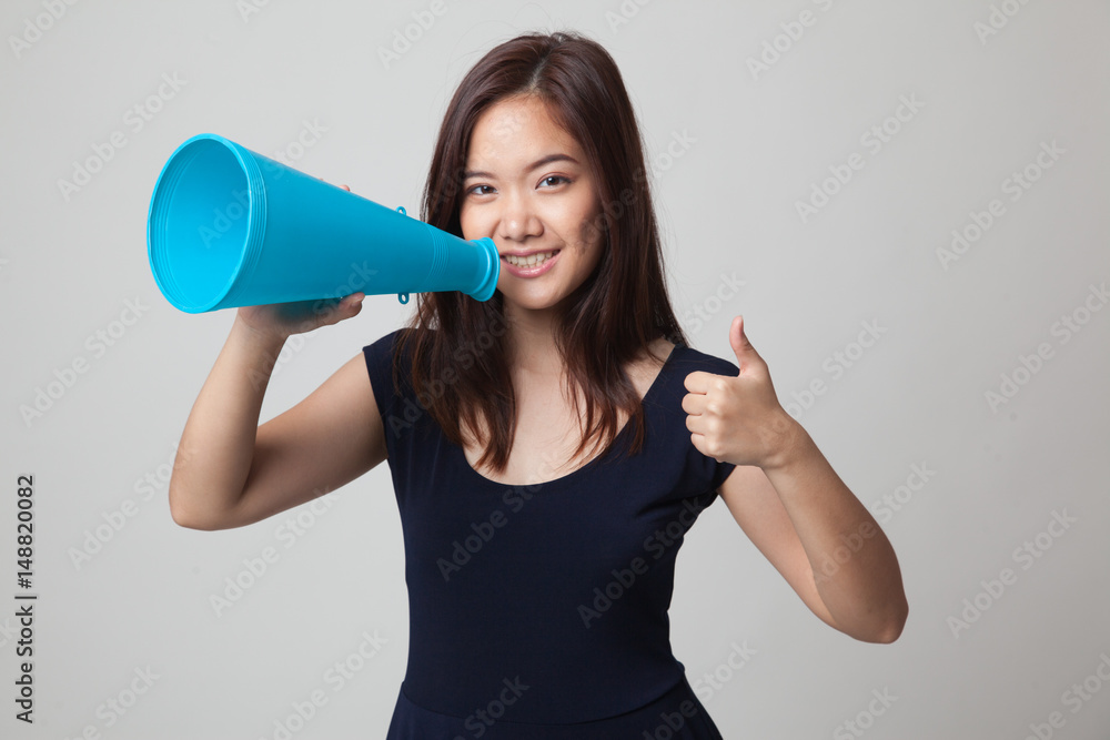Beautiful young Asian woman show thumbs up announce with megaphone. Beautiful young Asian woman show thumbs up announce with megaphone.
