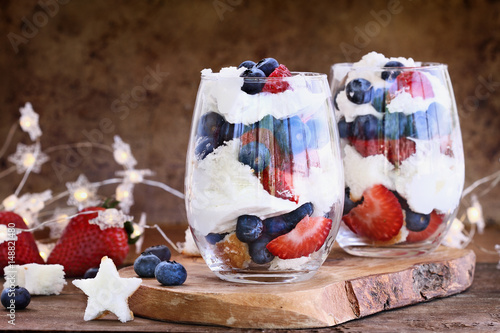 Canvastavla Trifle made with blueberries, strawberries, whipped cream and star shaped pound cake against a rustic background