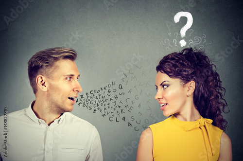 Man talking to an attractive woman with question mark photo
