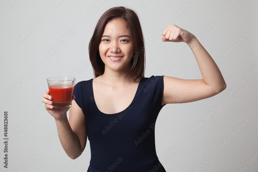 Strong healthy Asian woman with tomato juice. Strong healthy Asian woman with tomato juice.