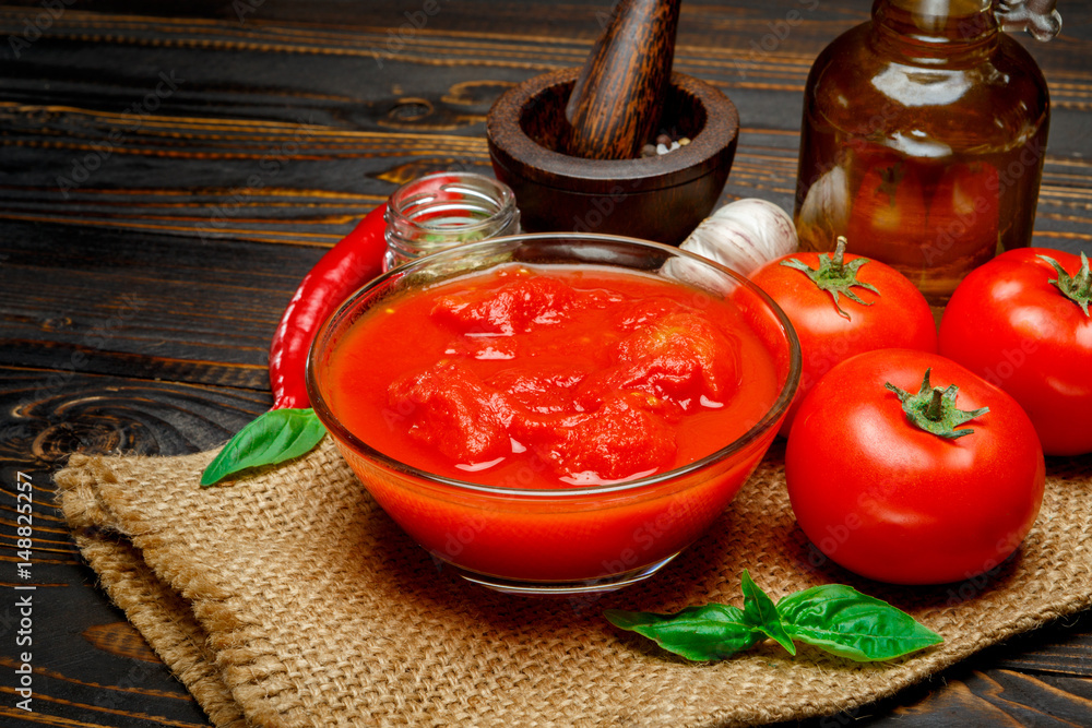 tomato sauce or puree on wooden table tomato sauce or puree on wooden table