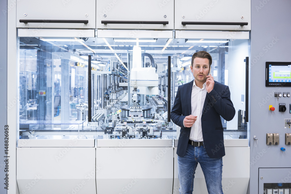 Man in factory shop floor on the phone Man in factory shop floor on the phone