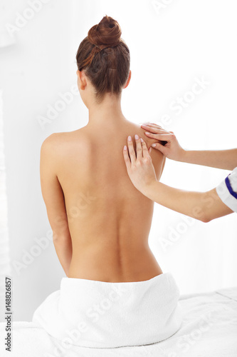 A picture of woman having back therapy
