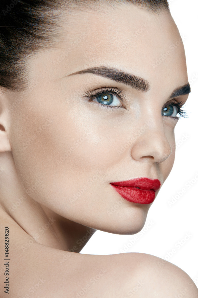Fashion Makeup. Young Woman With Perfect Makeup And Red Lips