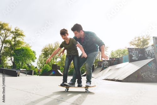 Father Learning his son to skate