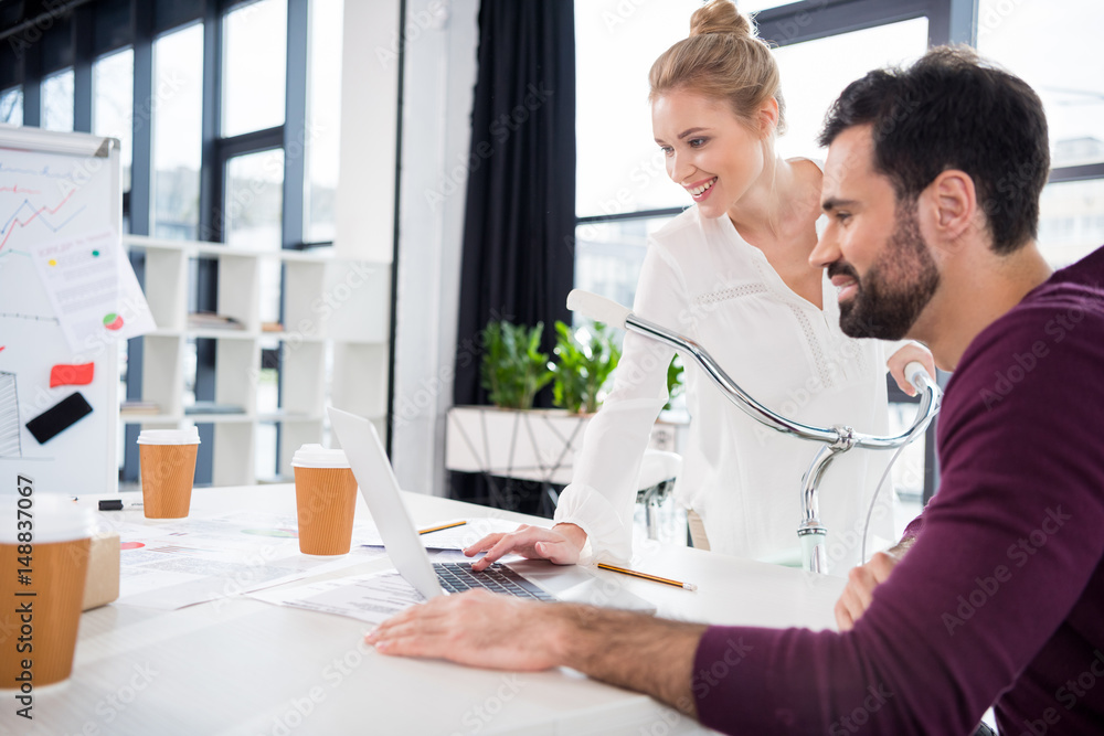 © LIGHTFIELD STUDIOS - businessman and businesswoman working with laptop together on workplace in office, young professionals concept © LIGHTFIELD STUDIOS - businessman and businesswoman working with laptop together on workplace in office, young professionals concept