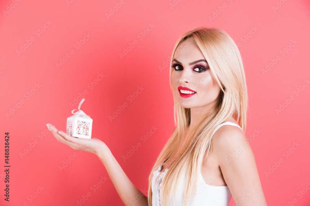young seductive blonde woman hold small white gift box young seductive blonde woman hold small white gift box